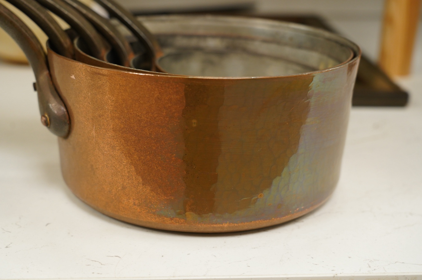 A set of five graduated copper pans, largest diameter 21cm. Condition - fair to good